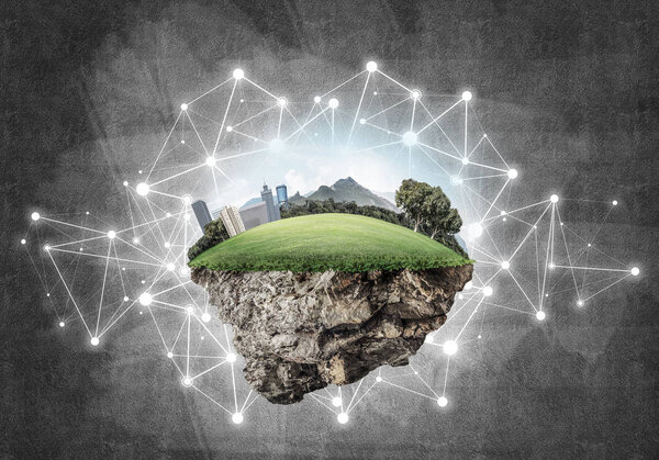 Маленький остров с травой и городом на бетонном фоне
