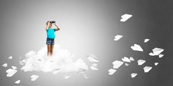 Concept of careless happy childhood with girl looking in binoculars — Stock Photo, Image