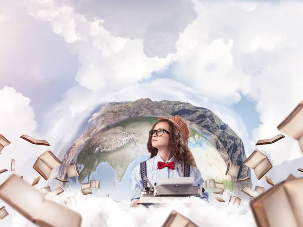 Portrait of thoughtful woman writer looking away and using typing machine while sitting at the table with flying books and Earth globe among cloudy skyscape on background. Elements of this image furnished by NASA
