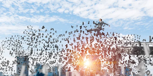 Businessman jumping over gap with flying letters in concrete bridge as symbol of overcoming challenges. Cityscape with sunlight on background. 3D rendering.