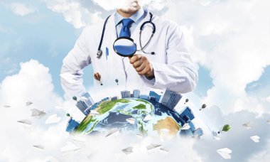 Genç ama beyaz steril giysi ve dünya küre ile bulutlu gökyüzü arka plan üzerinde büyüteç aracılığıyla keşfetmek ve boynunda steteskop profesyonel adam doktor. Tıp sektöründe kavramı. Nasa tarafından döşenmiş bu görüntü unsurları