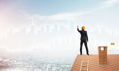 Mühendis, evinin çatısına geri döndü ve şehri çiziyor. Karışık ortam