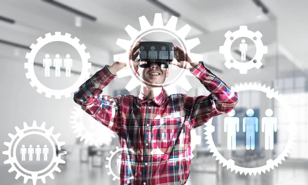 Young man with virtual reality headset or 3d glasses over social connection background