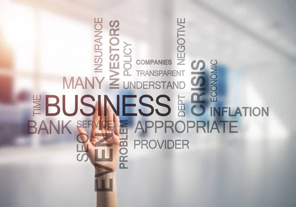 Close of businesswoman hand touching screen with business conceptual words