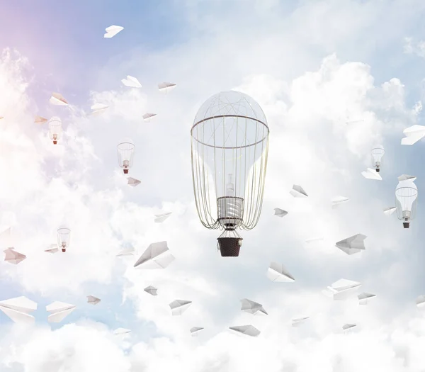 Colorful aerostats flying among paper planes and over the blue cloudy sky. 3D rendering.