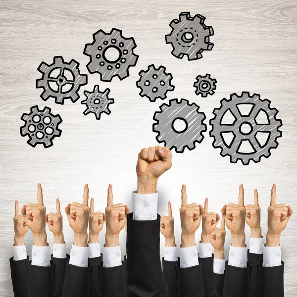 Group of hands of businesspeople showing gestures on wooden background