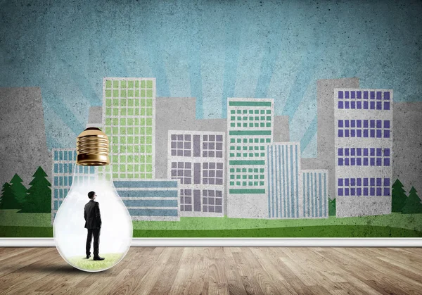 Businessman inside light bulb against city drawn concept