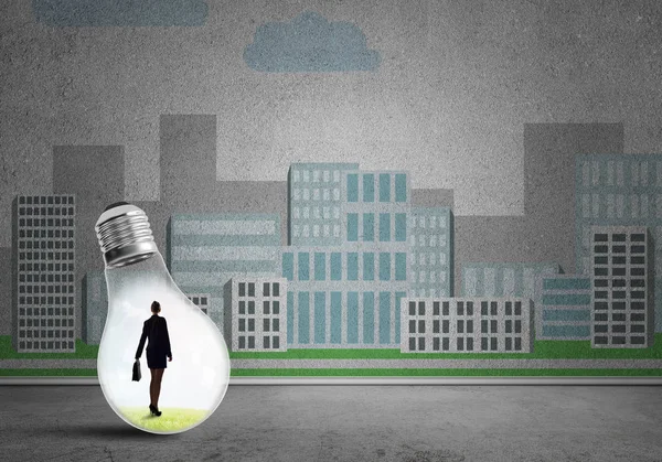 Businesswoman trapped in bulb — Stock Photo, Image