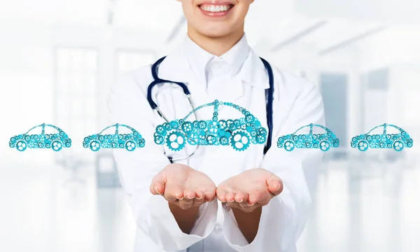 Woman doctor presenting in palms concept of car transporation or insurance