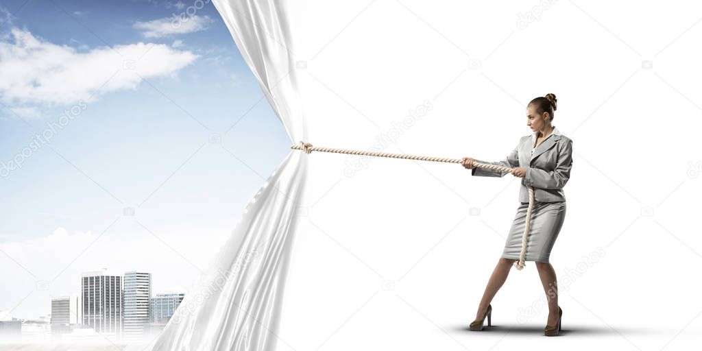 Businesswoman pulling white blank fabric. Place for text