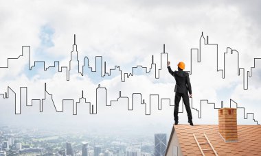 Mühendis, evinin çatısına geri döndü ve şehri çiziyor. Karışık ortam