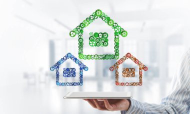 İşadamlarının elinde tablet tablet ve bağlı viteslerden oluşan tabela var. Karışık ortam