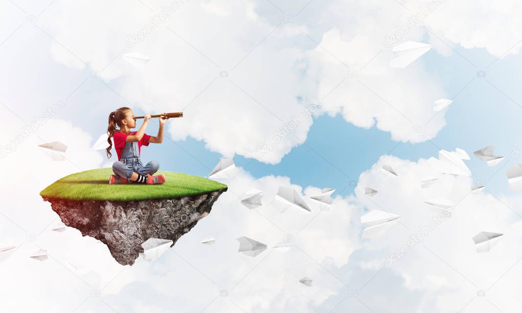Cute smiling girl sitting on floating island high in sky