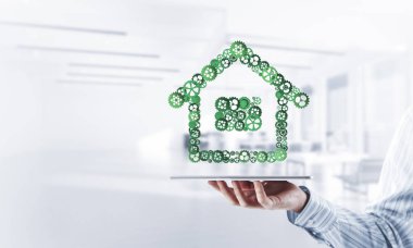 İşadamlarının elinde tablet tablet ve bağlı viteslerden oluşan tabela var. Karışık ortam