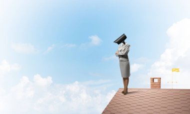 Evin çatısında baş durmak yerine kamerayla zum yapan yüzsüz iş kadını.