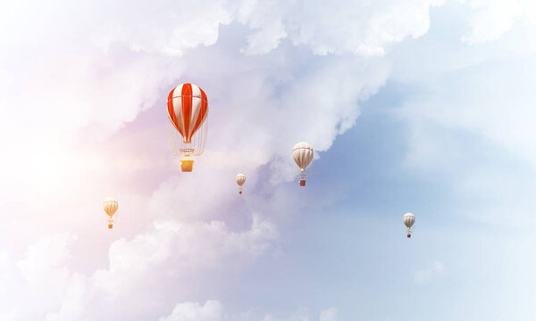 Colorful aerostats flying over the blue cloudy sky. 3D rendering.