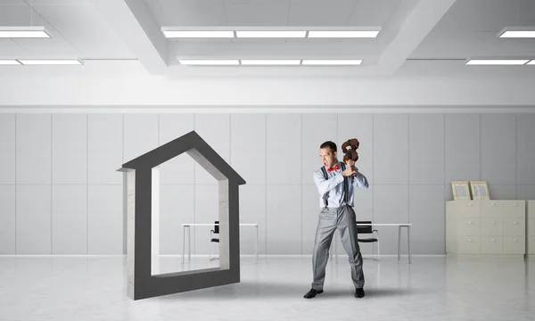 Determined businessman going to break with violin house concrete figure