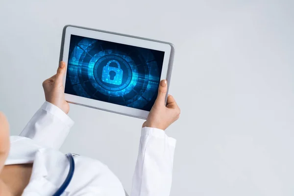 Tablet pc device with security padlock on screen in hands of doctor