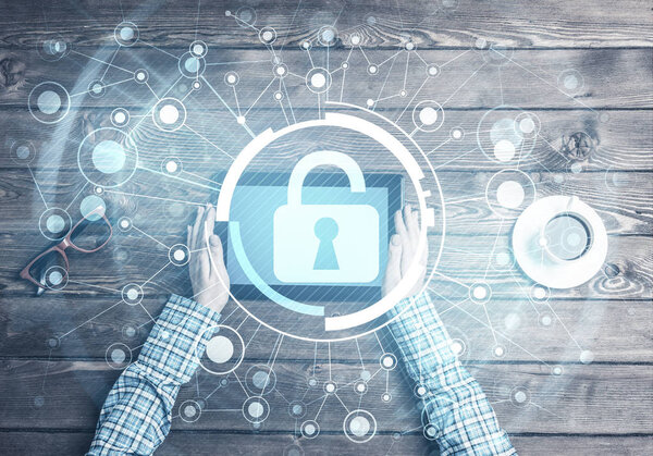 Top view of woman in casual sitting at wooden table with tablet pc