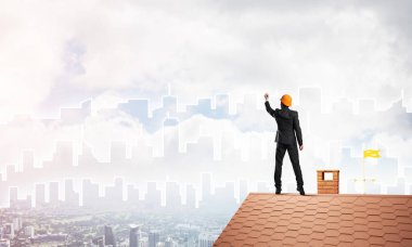 Mühendis, evinin çatısına geri döndü ve şehri çiziyor. Karışık ortam