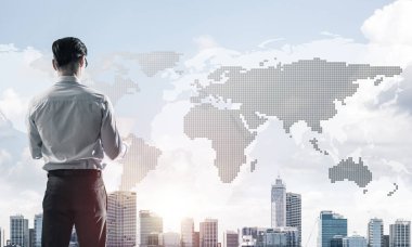 Genç ve zarif iş adamı arkasını dönüp iş şehrine bakıyor.