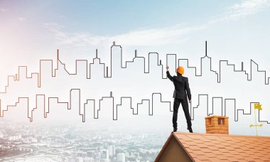 Mühendis, evinin çatısına geri döndü ve şehri çiziyor. Karışık ortam