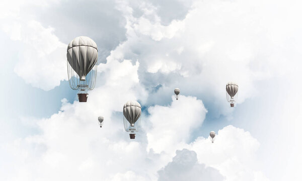 Colorful aerostats flying over the blue cloudy sky. 3D rendering.