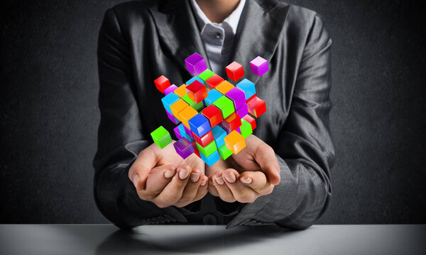 Обрезанный образ деловой женщины в костюме, представляющий несколько кубиков в руках как символ инноваций. 3D рендеринг
.