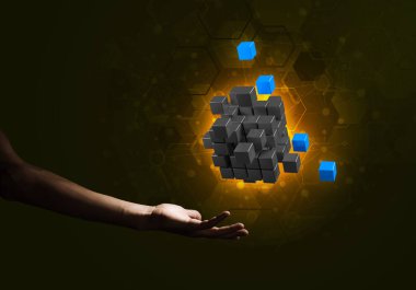 Yeniliğin sembolü olarak insan eli küp figürüne yakın olmak. Karışık ortam.