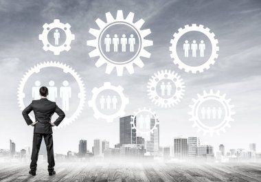 Modern şehir manzarası ve vites bağlantısı fikrine bakan işadamlarının arka planı