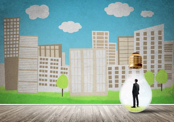 Businessman inside light bulb against city drawn concept