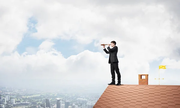 Young Determined Businessman Standing House Roof Looking Spyglass Mixed Media — Stock Photo, Image
