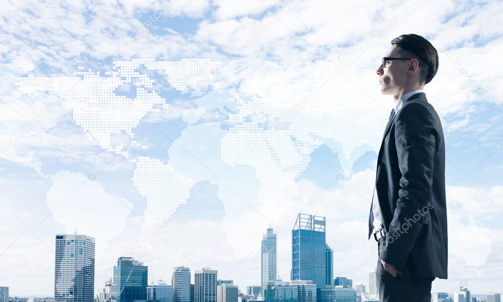 Young elegant businessman with hands in pockets looking away