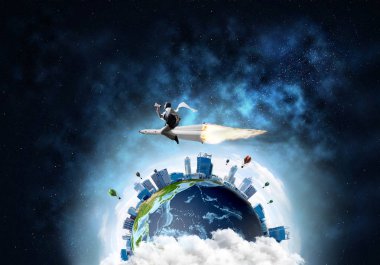 Arka plan üzerine açık alan ve dünya ile roket üzerinde uçan takım elbiseli genç işadamı kavramsal görüntü. Bu görüntü unsurları Nasa tarafından döşenmiştir.