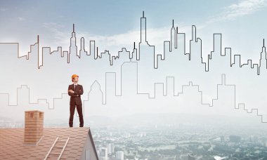 Takım elbiseli genç işadamı ve çatıda kask var. Karışık ortam