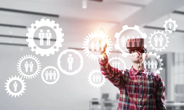 Young man with virtual reality headset or 3d glasses over social connection background