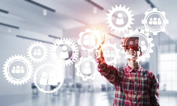 Young man with virtual reality headset or 3d glasses over social connection background