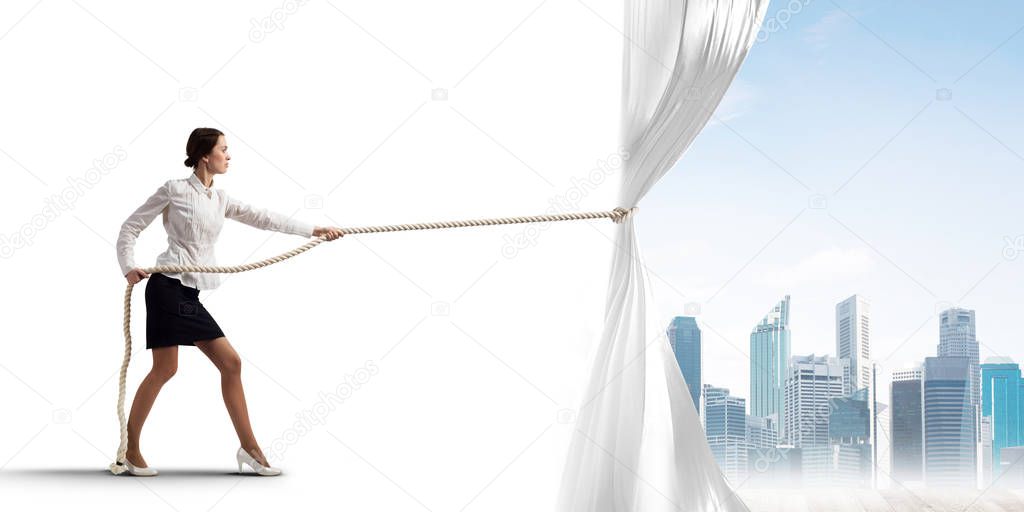 Businesswoman pulling white blank fabric. Place for text