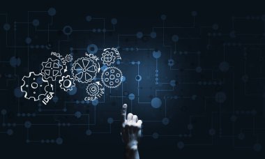 İş adamının eli dişli mekanizmasını işaret ediyor.