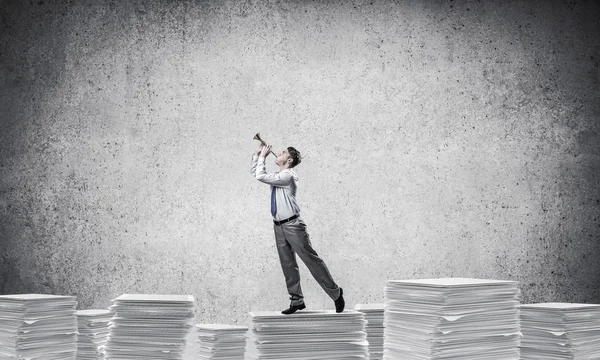 Businessman Playing Fife While Standing Pile Documents Grey Background Mixed — Stock Photo, Image