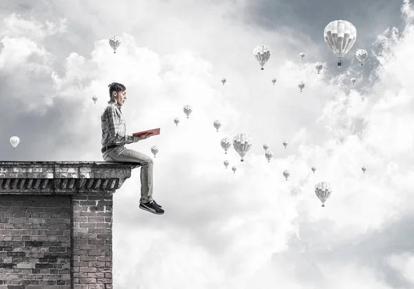 Young Shocked Man Student Sitting Building Top Red Book Hands — Stock Photo, Image