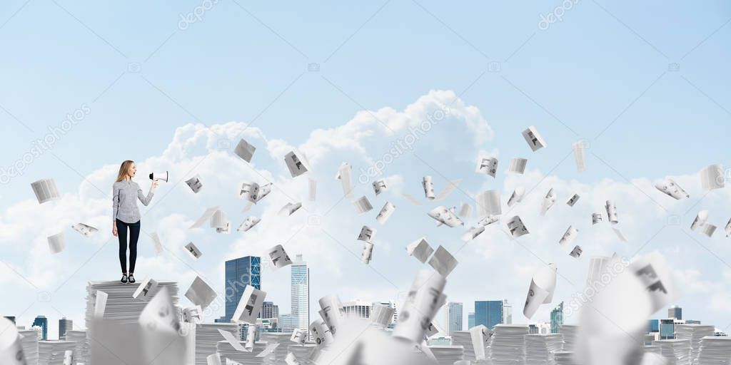 Woman in casual clothing standing among flying papers with speaker in hand and with skyscape on background. Mixed media.