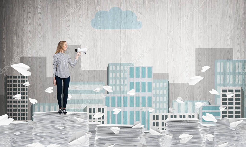 Woman in casual clothing standing among flying paper planes with speaker in hand with sketched cityscape view on background. Mixed media.
