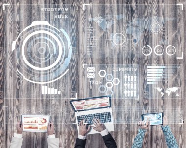 Ellerinde cihazlar bulunan üç kişilik bir grup iletişim ve ağ oluşturma sembolü olarak birlikte çalışıyor.