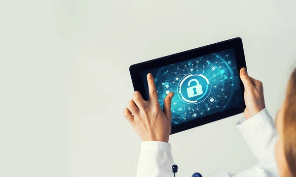Tablet pc device with security padlock on screen in hands of doctor