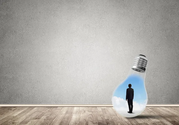 Businessman Light Bulb Empty Concrete Room — Stock Photo, Image