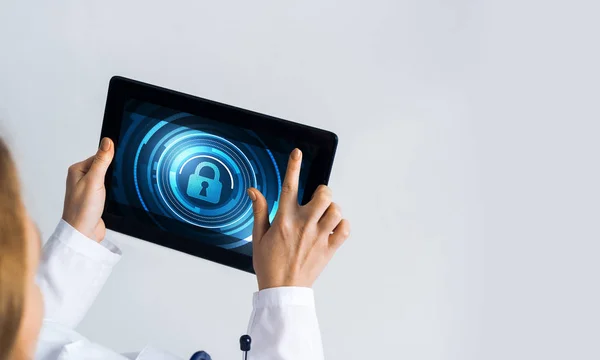 Tablet pc device with security padlock on screen in hands of doctor