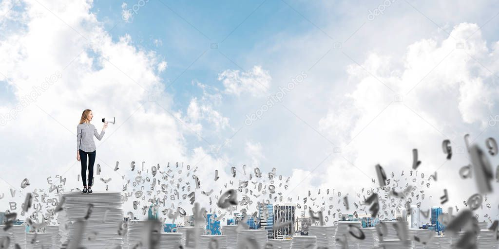 Woman in casual clothing standing among flying letters with speaker in hand and with skyscape on background. Mixed media. 