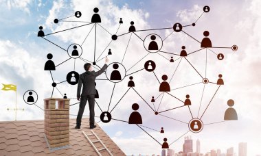 Delikanlı çatıda dikiliyor ve bağlantı hatları çiziyor. Karışık ortam