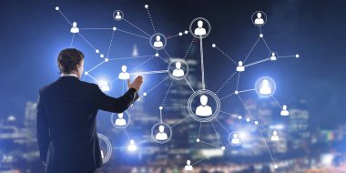 İşadamı gece cityscape sosyal bağlantı medya kavramı ile çalışma karşı arkadan görünüm